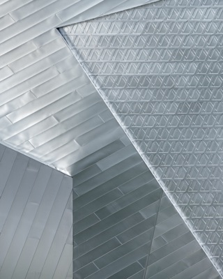 Abstract architectural detail of intersecting planes, diagonal strips and geometric relief patterns in pale grey tones — Las Vegas.